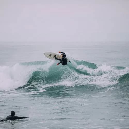 A surfer riding a wave in Imsouane